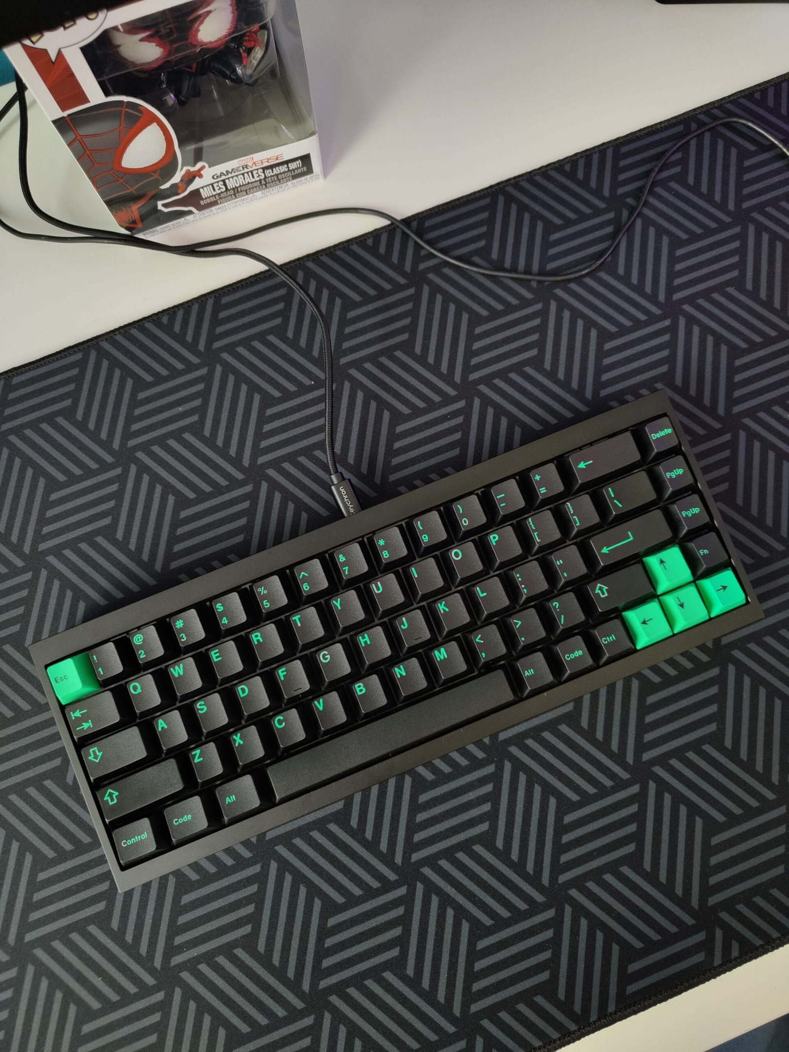 Blue and black mechanical keyboard on a cork deskmat