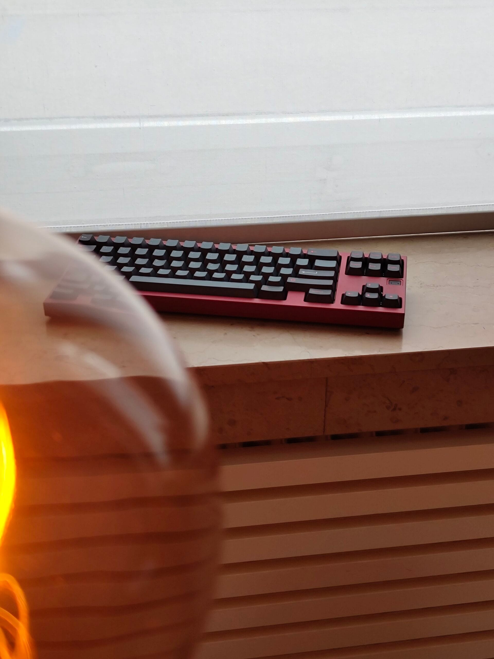 Red keyboard on a wooden shelf