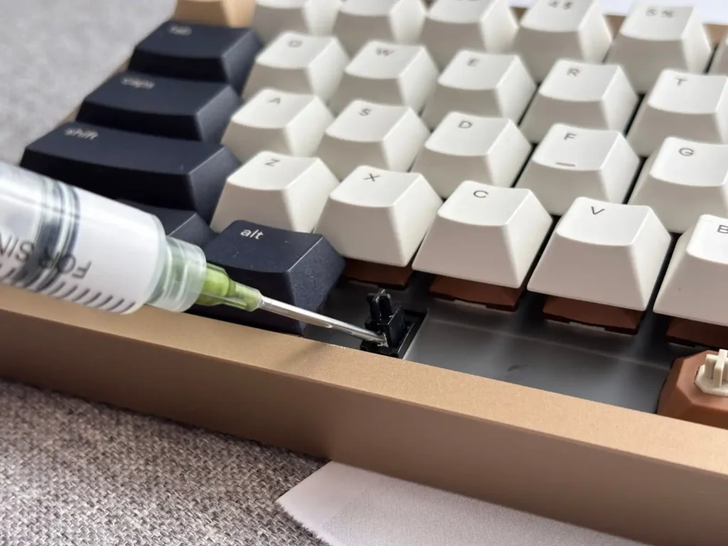 Keyboard stabilizers getting tuned with a lube syringe